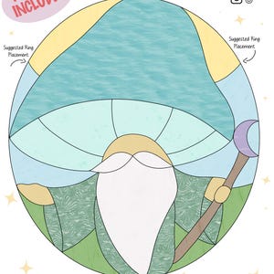 May include: A stained glass pattern of a gnome wearing a blue hat and holding a staff with a crescent moon on top. The pattern is in a circle with a yellow, blue, and green background. The text "She's All Glass" is at the top of the image.