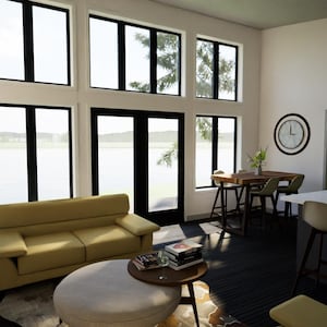 May include: A modern living room with large windows and a view of the water. The room features a yellow sofa, a round ottoman, and a small wooden table with books. A clock hangs on the wall, and a kitchen area is visible.