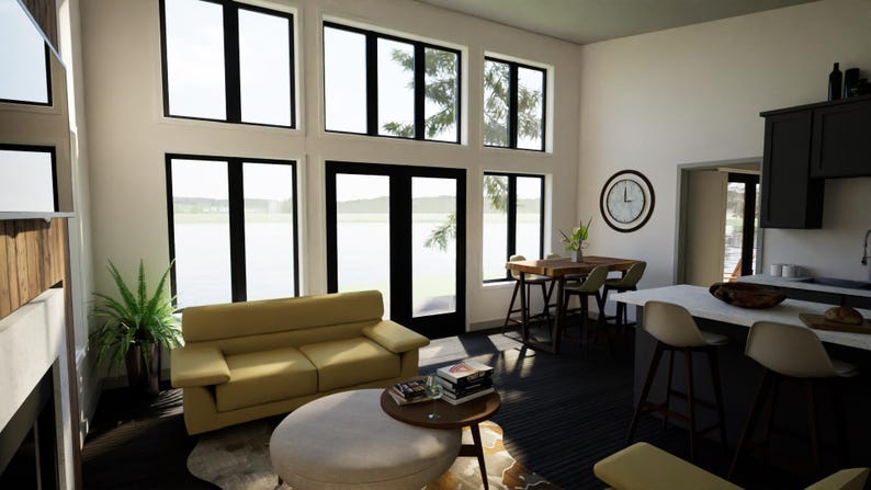 May include: A modern living room with large windows and a view of the water. The room features a yellow sofa, a round ottoman, and a small wooden table with books. A clock hangs on the wall, and a kitchen area is visible.