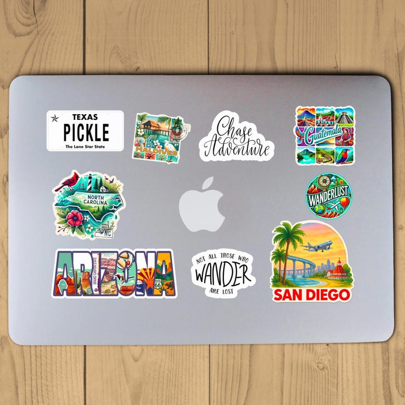 Puede incluir: Una colecci&oacute;n de pegatinas con tem&aacute;tica de viajes en un ordenador port&aacute;til. Las pegatinas incluyen textos como "Texas Pickle", "Chase Adventure", "Arizona" y "San Diego". Las pegatinas presentan varias ilustraciones y dise&ntilde;os.