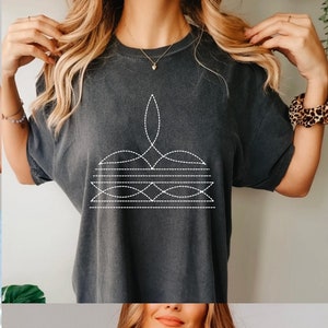 May include: Four t-shirts in different colors: blue, gray, brown, and black. Each shirt features a unique design of a stylized shape with dotted lines. The design colors match the shirt colors, except for the black shirt, which has a red design.