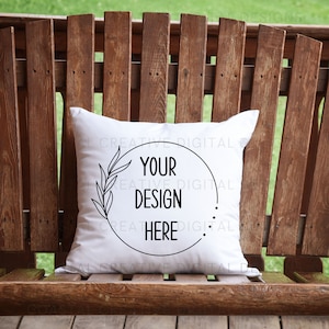 May include: White pillow with a black circle and the text "Your Design Here" inside the circle. The circle is surrounded by a black wreath.