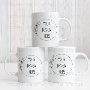 May include: Three white ceramic mugs with black outlines of leaves and a circle that says "Your Design Here".