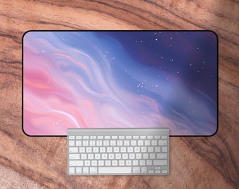 May include: A white keyboard with a black border sits on a pink and blue galaxy-themed desk mat. The mat has a starry night design with white stars on a dark blue background.