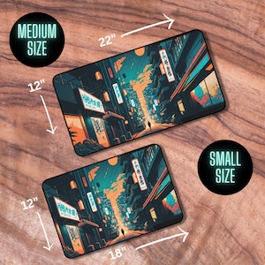 May include: Two different sizes of a mousepad featuring a colorful illustration of a city street at night. The street is lined with buildings with neon signs and a person walking down the middle of the street. The larger mousepad is 22 inches by 12 inches and the smaller mousepad is 18 inches by 12 inches.