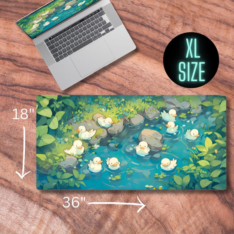 May include: A large, 36 inch by 18 inch mousepad featuring a whimsical illustration of white ducks swimming in a blue stream. The stream is surrounded by green foliage and rocks. The mousepad is labeled "XL SIZE".