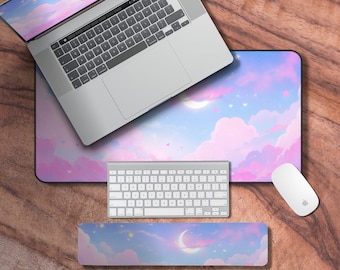 May include: A pink and blue cloud-themed mousepad with a crescent moon and stars. A white keyboard and mouse are on the mousepad. A matching wrist rest is also included.