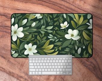 May include: A green and white floral design mouse mat with a white keyboard on a wooden surface.