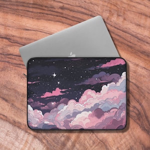 May include: A laptop sleeve with a pink and purple cloud design against a dark blue starry night sky. The sleeve has a black zipper.