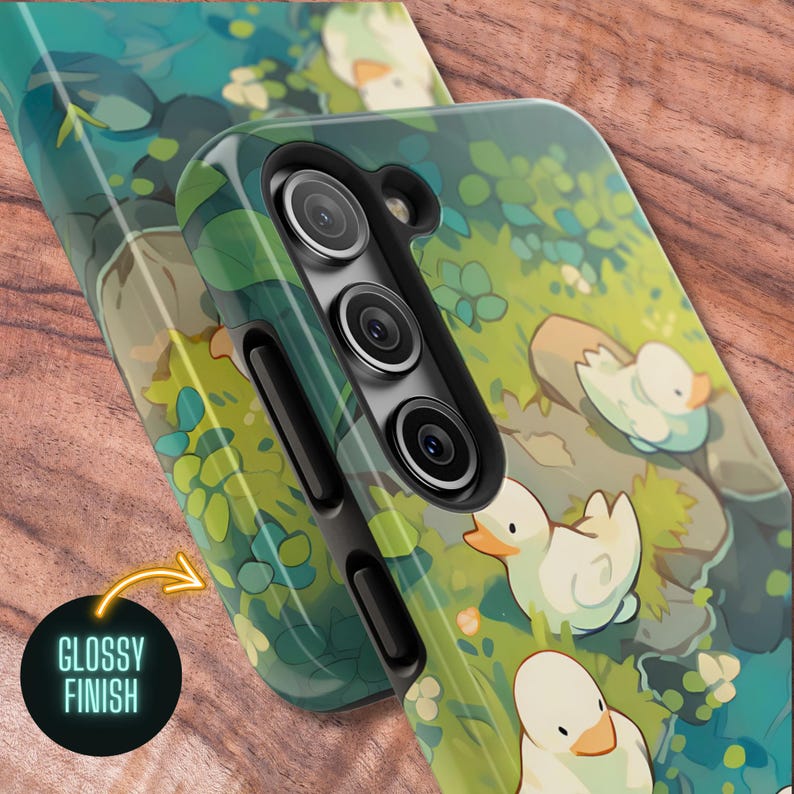 May include: A green and white phone case with a glossy finish. The case features a cartoon illustration of ducks in a forest setting.