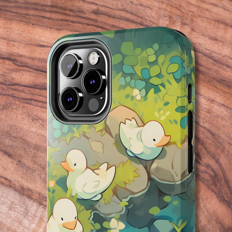 May include: A phone case with a green and blue nature scene featuring three white ducks. The case has a black camera cutout with three lenses.