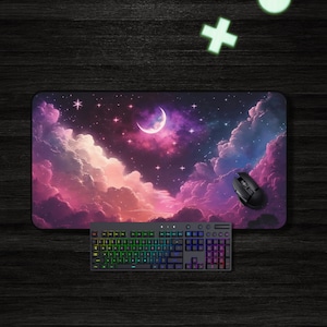 May include: A black and grey gaming keyboard with rainbow colored keys and a black mouse on a purple and pink starry night sky mousepad.