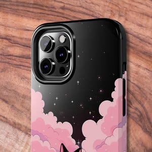 May include: Black phone case with a pink and purple cloud design and a starry night sky background. The case has a raised camera bump with three lenses.