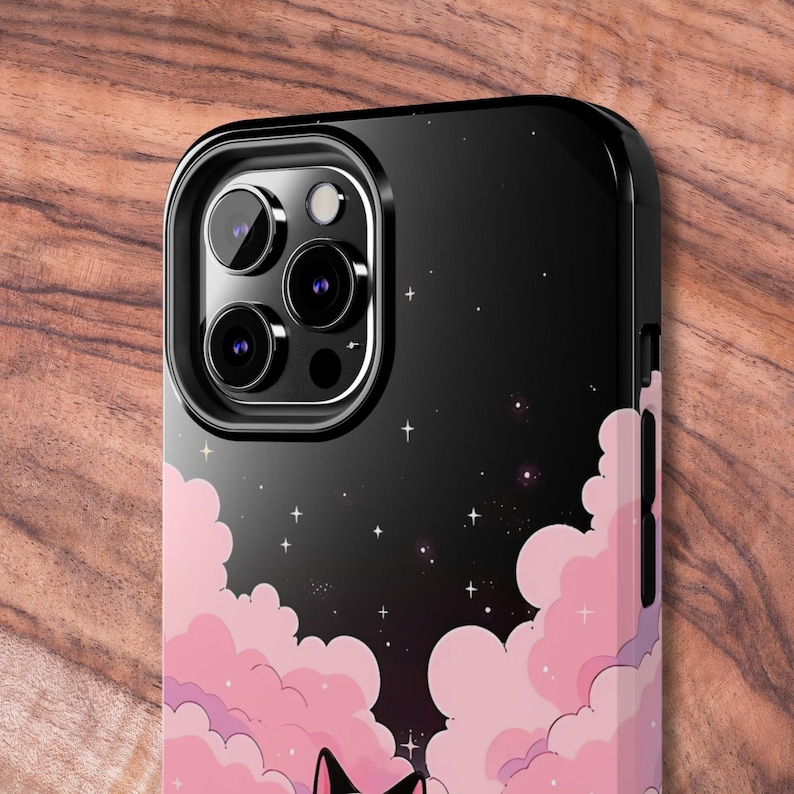 May include: Black phone case with a pink and purple cloud design and a starry night sky background. The case has a raised camera bump with three lenses.