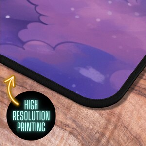 May include: A purple and white mouse mat with a black stitched edge. The mouse mat features a design of clouds and stars. The text "HIGH RESOLUTION PRINTING" is visible on the bottom right corner of the image.