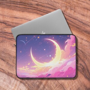 May include: A laptop sleeve with a crescent moon and stars on a purple and pink cloudy sky background.