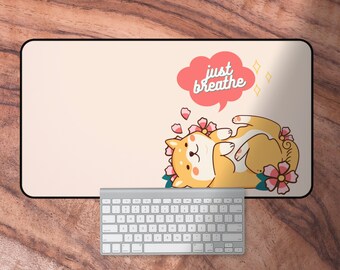 May include: A light pink mousepad with a cartoon Shiba Inu dog wearing a flower crown and the text "just breathe" in a speech bubble. The dog is lying on its back with its paws in the air.