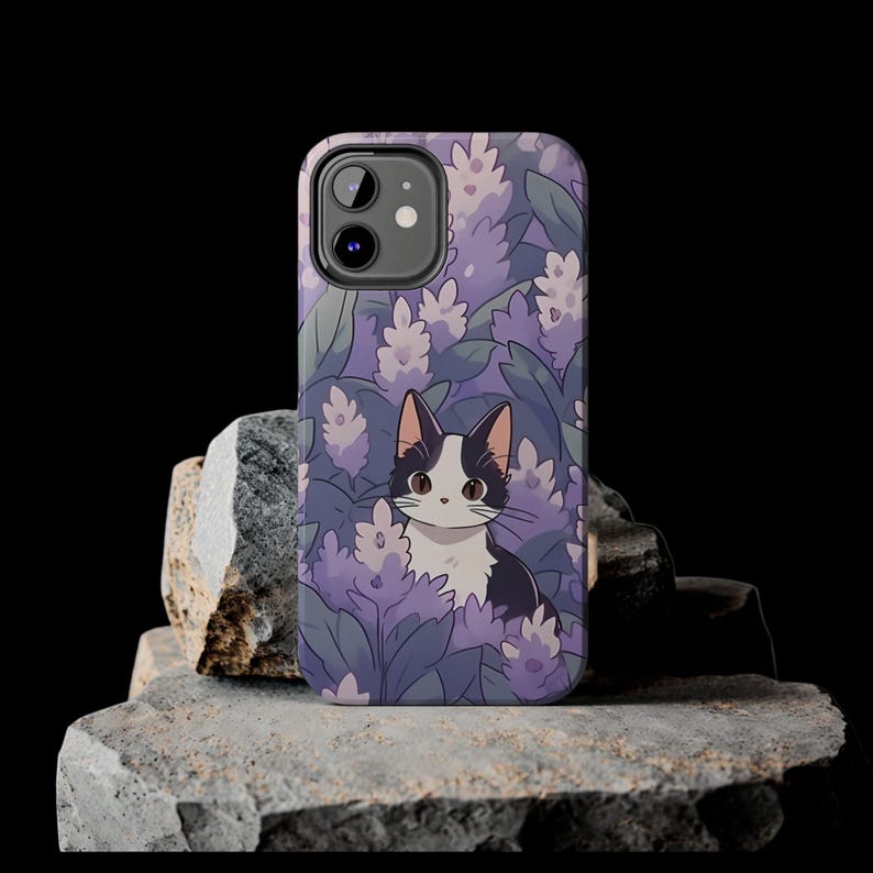 May include: A purple and white phone case with a black and white cat illustration. The cat is surrounded by purple flowers and leaves.