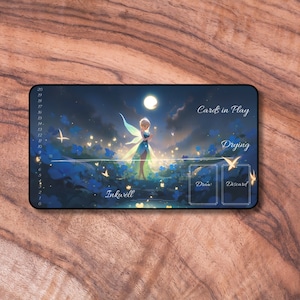May include: A blue and green fairy with wings stands in a field of blue flowers under a full moon. The text "Inkwell" is at the bottom of the image. The text "Cards in Play" is at the top right of the image. There are two card slots labelled "Draw" and "Discard". The text "Drying" is above the card slots.