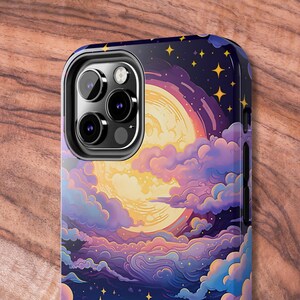 May include: A phone case featuring a colourful illustration of a moon, clouds and stars. The case has a cut-out for the phone's camera.
