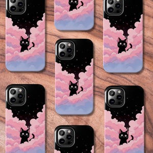 May include: Ten phone cases with a black cat design. The cases are black with a starry night sky background and pink clouds. The cat is sitting on a cloud with a pink and purple gradient.