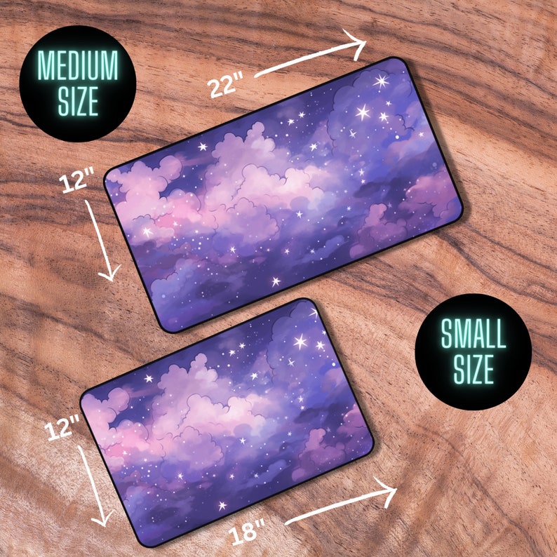 May include: Two mouse mats featuring a purple and pink starry night sky design. The larger mouse mat is 22 inches by 12 inches and the smaller mouse mat is 18 inches by 12 inches.