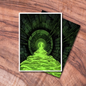 May include: Two art prints depicting a digital illustration of a green-lit tunnel with a flowing, glowing green substance. The tunnel is made of brick and metal, with a bright light at the end. The prints are on a wooden surface.