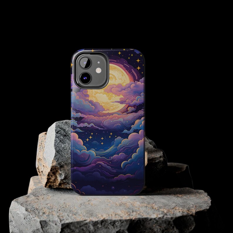 May include: A phone case featuring a colourful illustration of a moon and clouds against a dark blue background. The case has a cutout for the camera lens.