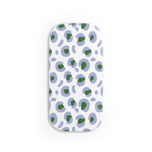 May include: A white oval-shaped tray with a repeating pattern of green and purple leopard spots.