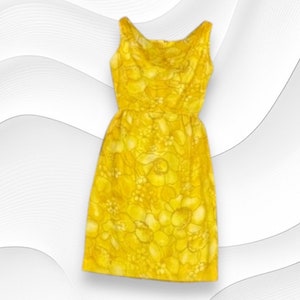 May include: A sleeveless yellow dress with a floral print. The dress has a scoop neck and a fitted bodice. The skirt is full and flows to the knees.