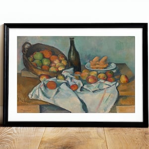 May include: A still life painting of a basket of apples, a bottle of wine, and a plate of pastries on a table covered with a white tablecloth. The painting is in a black frame.