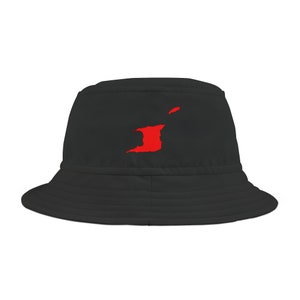 May include: Black bucket hat featuring a red graphic of the Trinidad and Tobago islands. The hat has a classic, casual design with a wide brim and a structured crown. The red graphic is centered on the front of the hat.