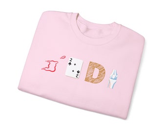 May include: A pink sweatshirt with the word "JDI" printed on it. The "J" is a red outline of the island of Trinidad and Tobago, the "D" is a brown, hand-drawn letter, and the "I" is a playing card with the number 2 of spades.