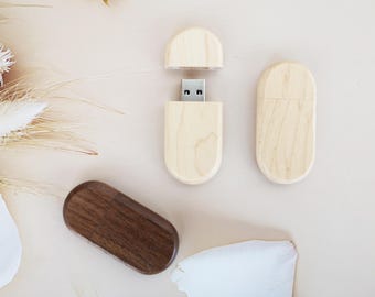 May include: Three wooden USB flash drives. Two are light wood and one is dark wood. The light wood drives are open to show the USB connector.