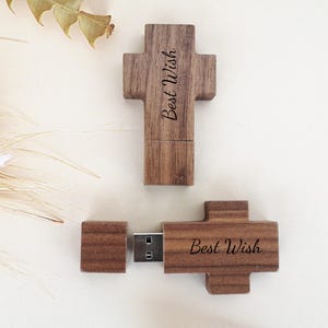 May include: A wooden cross-shaped USB flash drive with the text "Best Wish" engraved on it. The drive is separated into two pieces, with the USB connector visible.