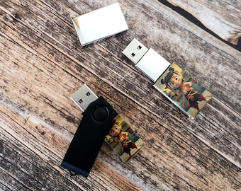 May include: Two USB flash drives, one silver and one black. The silver drive has a cartoon character on it. The black drive is a swivel drive.