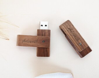 May include: Two wooden USB flash drives with the word "photograph" engraved on them. The drives are brown and have a natural wood finish.