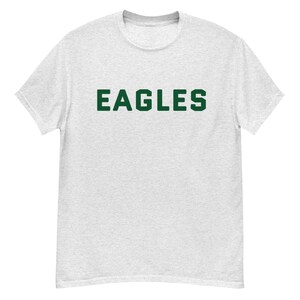 May include: A heather grey t-shirt with the word "EAGLES" printed in green.