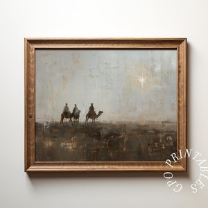 May include: A framed painting depicting three figures riding camels across a desert landscape. The sky is a muted blue with a bright star in the distance. The painting has a rustic, textured style.