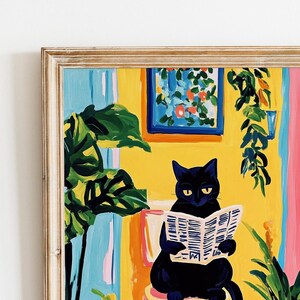 May include: A black cat sits in a yellow room with a newspaper in its paws. The cat is wearing a serious expression. The room is decorated with plants and a framed picture.