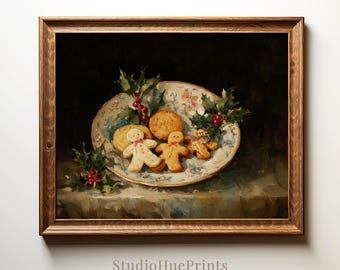 May include: A framed print depicting a still life of festive biscuits on a patterned plate, decorated with holly and red berries. Three gingerbread people are visible, alongside other round biscuits. The print is signed "StudioHuePrints".