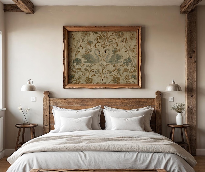 May include: A bedroom with a rustic wooden bed frame, white bedding, and a beige blanket. Above the bed is a framed artwork featuring two swans. Two small wooden side tables with lamps and a vase of flowers complete the room's decor.