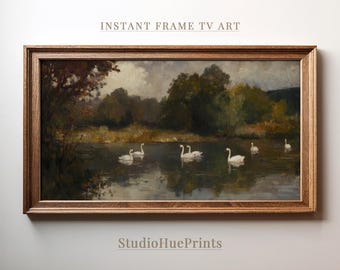 May include: A framed painting of a tranquil lake scene with five white swans swimming in the water. The lake is surrounded by trees and the sky is overcast. The painting is in a brown wooden frame.