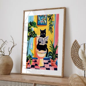May include: A black cat sits on a toilet reading a newspaper in a colorful bathroom with plants. The toilet is white with a pink seat and a yellow bowl. The walls are yellow, pink, and blue. The cat is wearing a black collar.