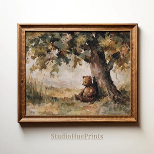 May include: A framed print of a teddy bear sitting under a tree. The artwork features a brown teddy bear, a large tree with green and brown leaves, and a grassy field. The frame is made of wood. The text "StudioHuePrints" is at the bottom.