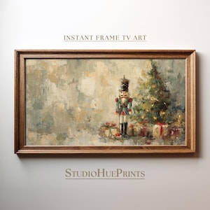 Puede incluir: Impresión enmarcada con una escena navideña. La obra de arte representa un cascanueces, un árbol de Navidad decorado y regalos envueltos. El marco es de color marrón cálido. El texto "INSTANT FRAME TV ART" y "StudioHuePrints" son visibles.