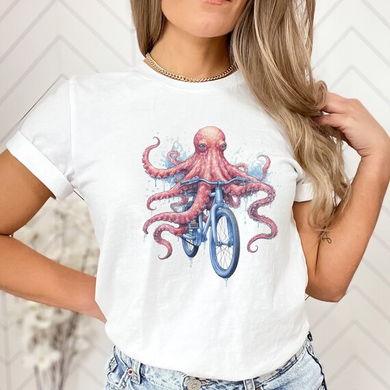 タコのユニセックス半袖Tシャツ、タコが自転車に乗っているシャツ