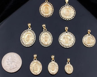 May include: A collection of gold-colored religious pendants in various sizes and designs, including oval and circular shapes. Some pendants feature intricate detailing and are adorned with small, sparkling embellishments. A U.S. quarter is included for size comparison.