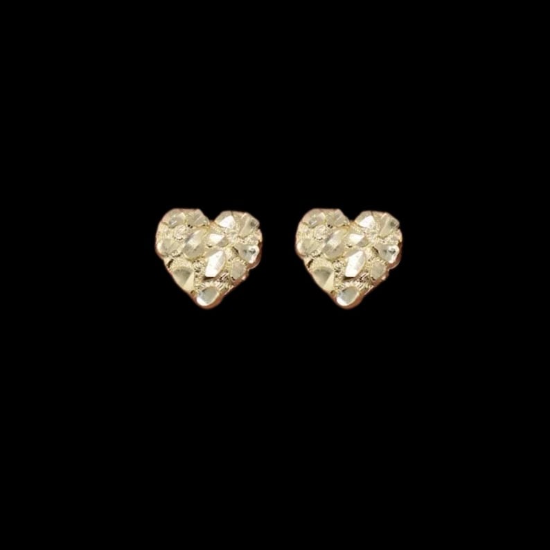 May include: A pair of gold heart-shaped earrings with a textured surface.