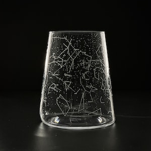 May include: A clear glass vase with a constellation design etched on the side. The constellations are labeled with their names, including Ursa Major, Orion, and Cassiopeia.